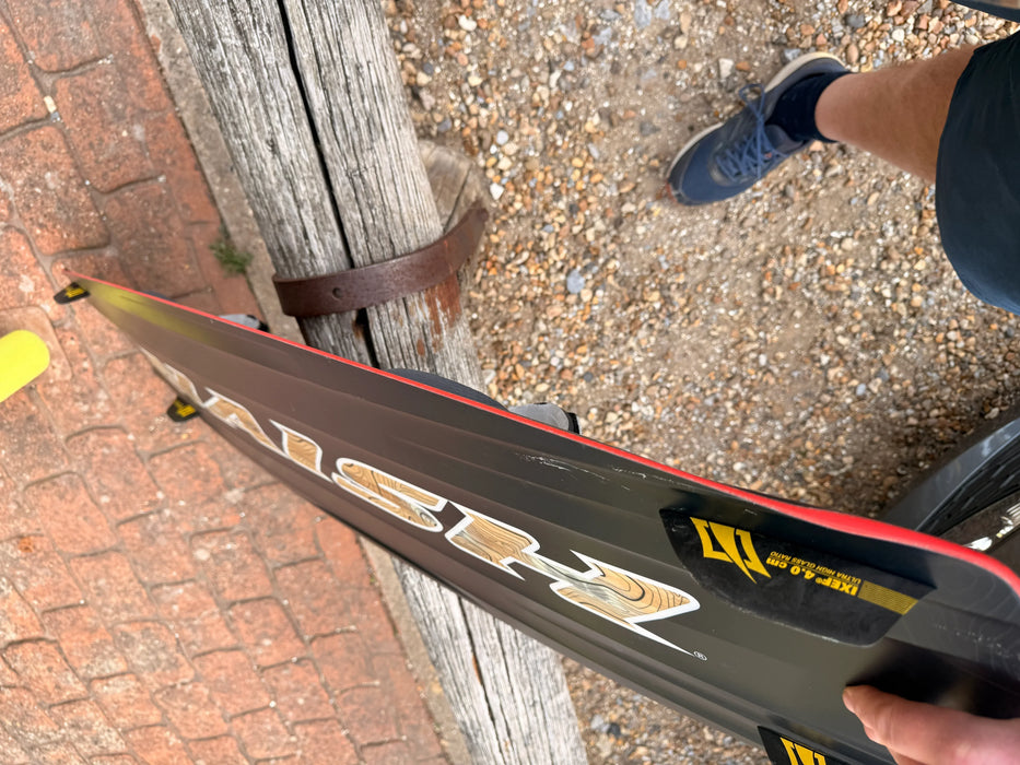 Naish Monarch kitesurfing board with black and red design and visible graphics