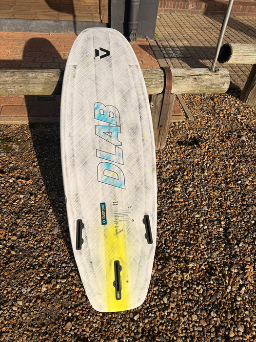 Duotone DLAB Whip D/LAB 5'3 surf kiteboard with white and yellow deck, outdoor setting