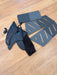 Duotone surfboard fins and grey deck pads set on a wooden floor, kite accessory kit