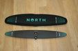 North Sonar S238 carbon stabilizer for wing foiling with black cover on wood floor