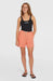 Woman wearing O'Neill black tank top and coral pink drawstring sweatshorts