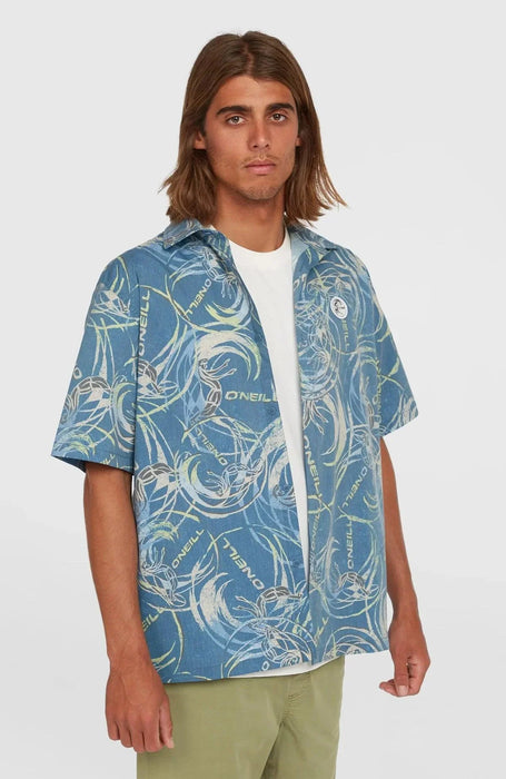 O'Neill blue short sleeve surf shirt with abstract print, worn by man, watersports clothing