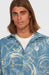 O'Neill blue short sleeve surf shirt with wave print and UPF 50, worn by male model