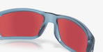 Matte transparent blue sunglasses with red mirrored lenses, close-up view.