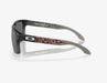 Oakley Holbrook sunglasses with black fade frame, Prizm black lenses, and red graphic arms