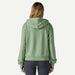 Woman wearing green Patagonia full zip hoodie, viewed from the back