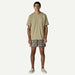 Patagonia olive t-shirt with pocket and patterned board shorts for watersports