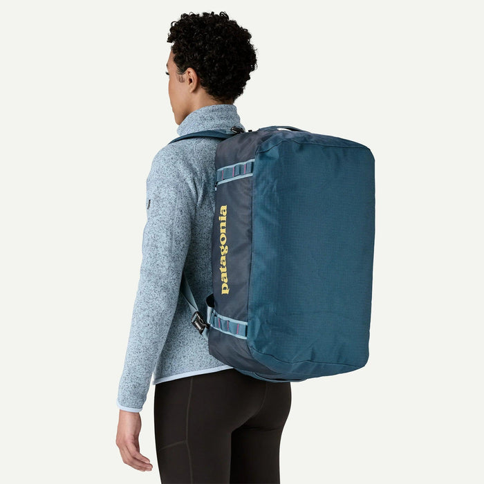 Patagonia Black Hole 40L tidal teal duffel bag worn as backpack