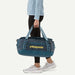 Patagonia Black Hole duffel bag 40L in tidal teal carried by person in sportswear
