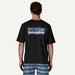 Patagonia black t-shirt with logo graphic, worn by man in striped blue boardshorts