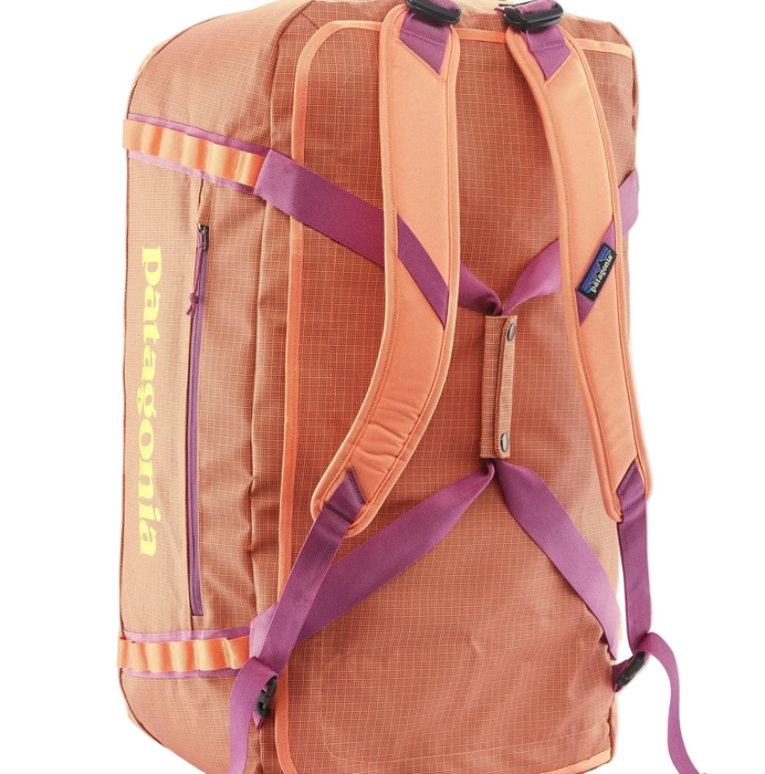 orange Patagonia backpack with purple straps on a white background