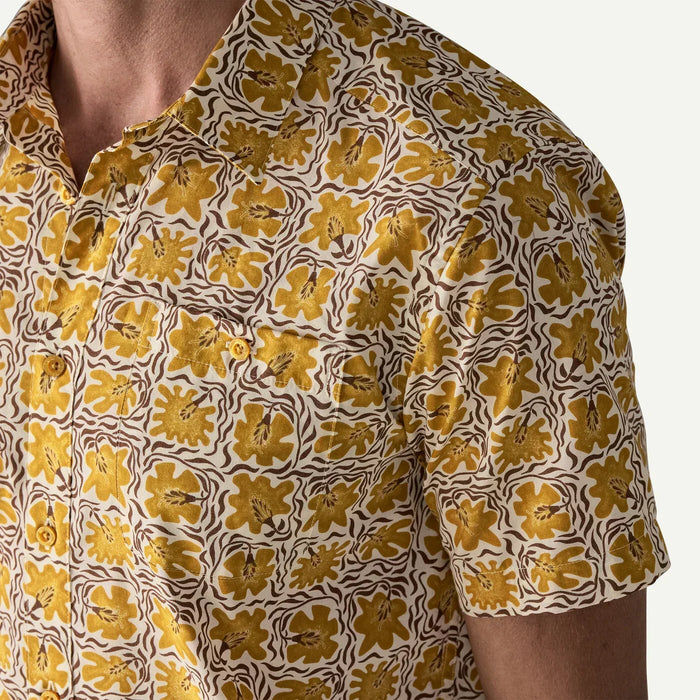Patagonia short sleeve shirt with yellow floral print on white, beachwear style