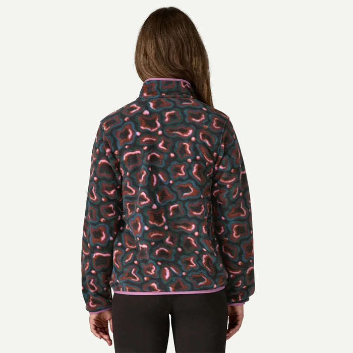 Woman wearing Patagonia fleece pullover with abstract pink and green pattern, back view