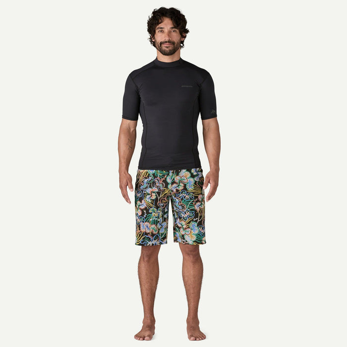 Patagonia men's black Hydropeak boardshorts with colourful undersea pattern, model standing