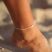 Pineapple Island Giada Melati shell beaded anklet, white, worn on ankle at the beach