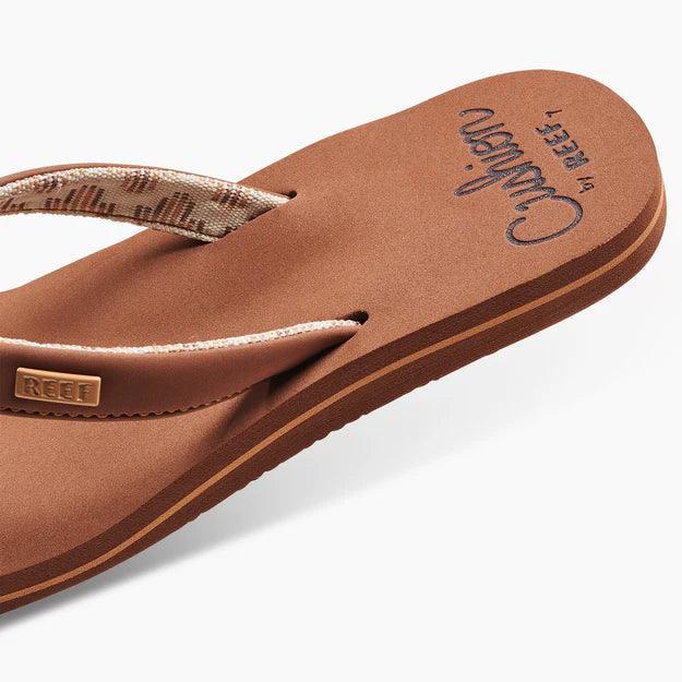 Reef Cushion Sands espresso flip flop with patterned strap, beach footwear.