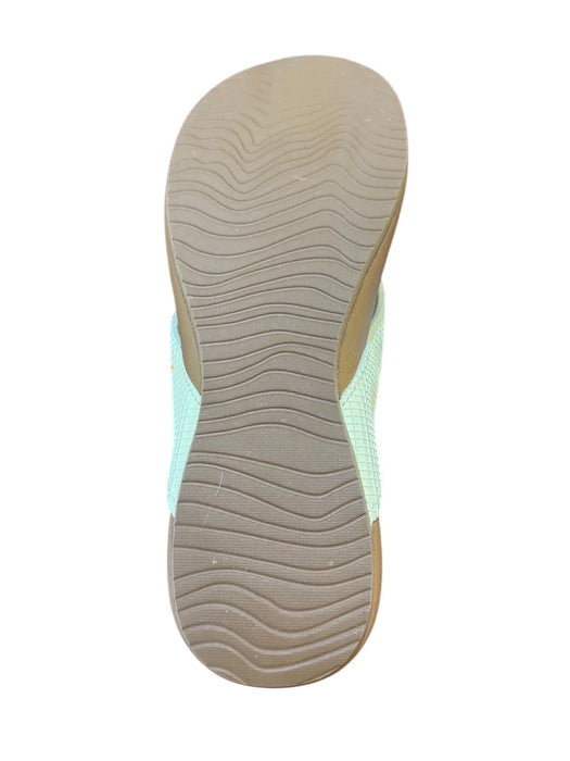 Women's flip flop with pale banana yellow textured sole and mint green straps, shown from sole