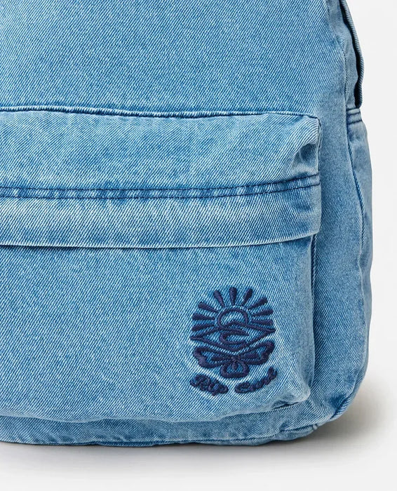 Light blue Rip Curl distressed denim backpack with front pocket and sun logo
