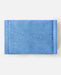 Rip Curl distressed blue denim wallet with visible stitching on white background