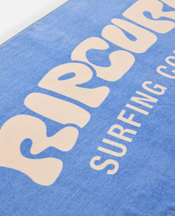 Rip Curl blue graphic beach towel with large logo and cream lettering, surf accessory