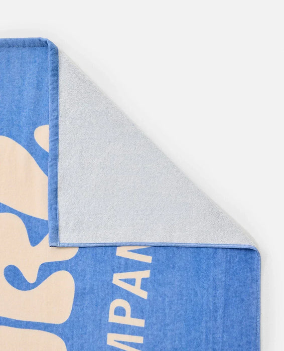 Rip Curl blue graphic beach towel with cream lettering, soft texture, corner folded