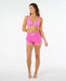Rip Curl high waist retro volley boardshorts in super pink with white trim, worn by woman