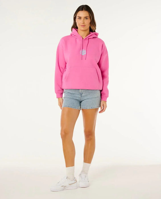 Rip Curl pink surf hoodie with front logo, worn by woman in denim shorts and white trainers