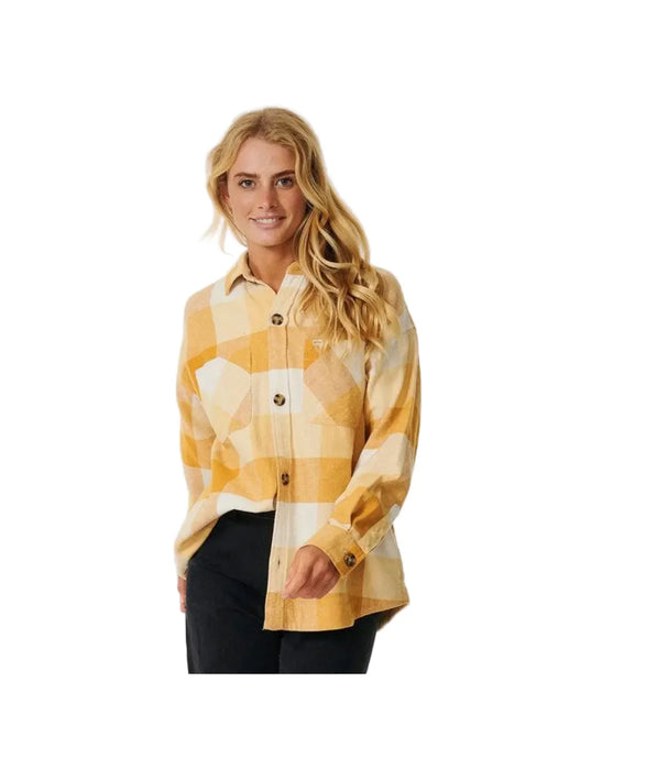 Woman wearing a yellow plaid shirt on a product page with Rip Curl branding.