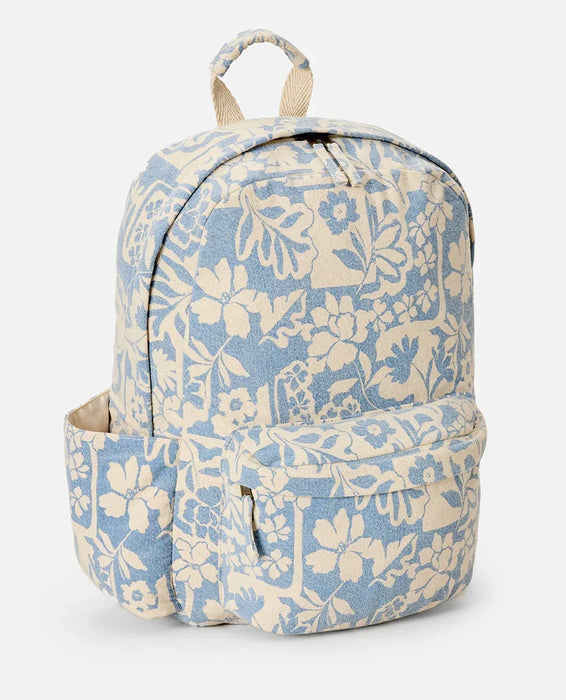 Rip Curl canvas backpack in blissful blue with floral print, front and side pockets visible