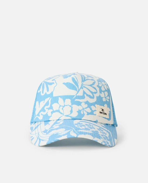 Rip Curl trucker cap in blissful blue with white floral pattern, mesh back, and front logo patch