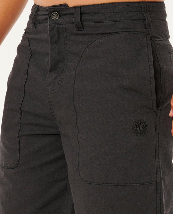 Rip Curl Premium Surf black walkshorts with logo patch, close-up on front pockets