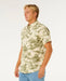 Rip Curl short sleeve shirt in vintage white with tropical print, worn by male model