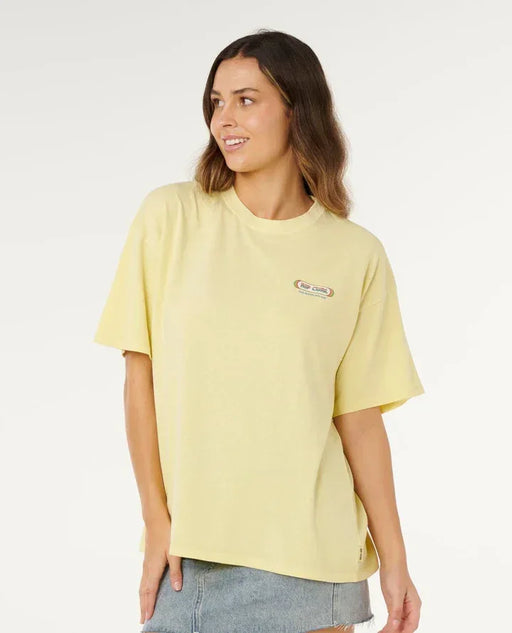 Rip Curl Surf Revival Heritage pastel yellow t-shirt with logo, worn by woman