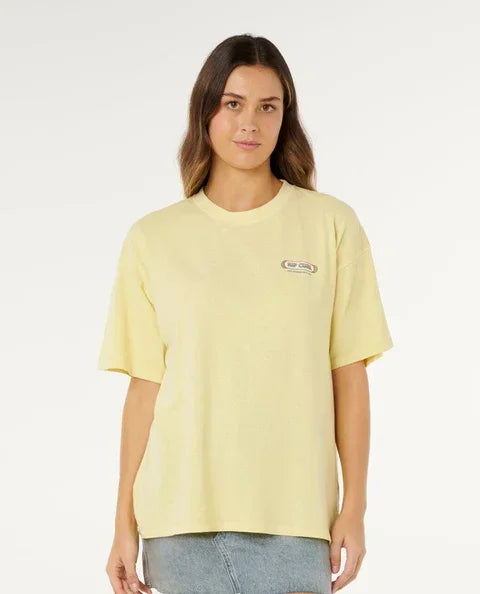 Rip Curl pastel yellow surf t-shirt with small chest logo, worn by woman