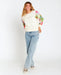 Rip Curl crew fleece sweatshirt with wavy print sleeves, cream front, worn by woman in jeans