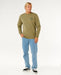 Rip Curl green crew neck sweatshirt with logo, surf clothing, worn by man in jeans and sneakers