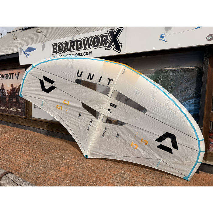 Used Duotone Unit SLS 5.5m 2025 wing foiling wing, full wing outside the Board-Worx shop, white with blue and yellow tips