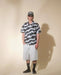 Man wearing Volcom Carolina Blue patterned short sleeve shirt, denim shorts, black socks, and cap