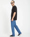 Volcom Solver jeans in bold blue, straight fit, modeled with black t-shirt and trainers