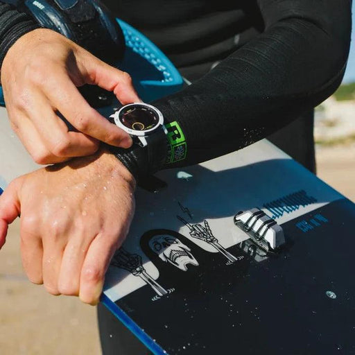 Woo kiteboard sensor 4.0 attached to a blue and black kiteboard with rider in wetsuit