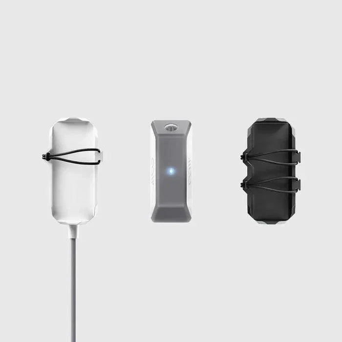 WOO 4.0 kiteboard sensor package with black and white mounts, grey device in center