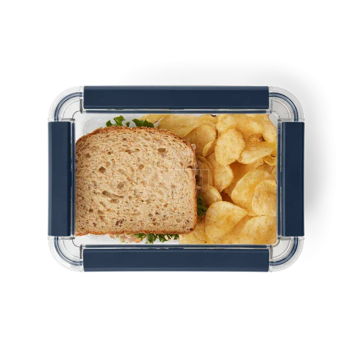 Yeti food storage container with blue clips, holding a sandwich and crisps