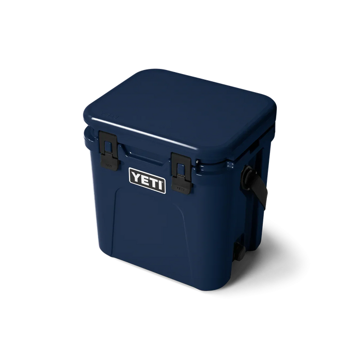 YETI Roadie 24 hard cooler in navy blue with black latches and side handle